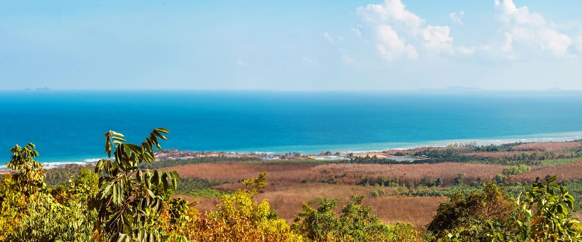 Viewpoint on Chumphon coastline from Buddha gold statue at Wat Khao Chedi-Phra Yai temple located on top of hill, Pathio, Chumphon district, Thailand