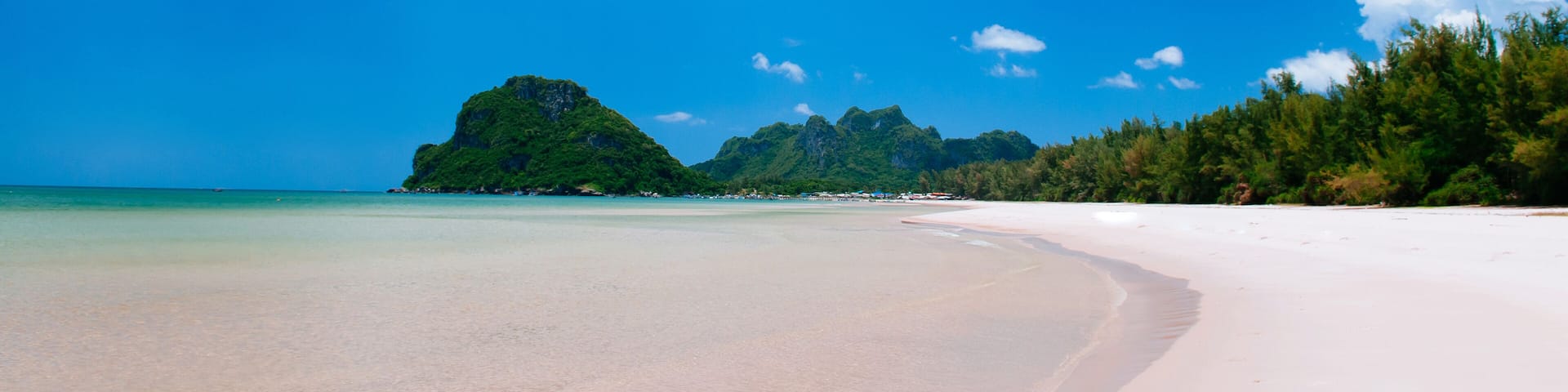 Tropical island white sand beach with blue sky and clouds in summer