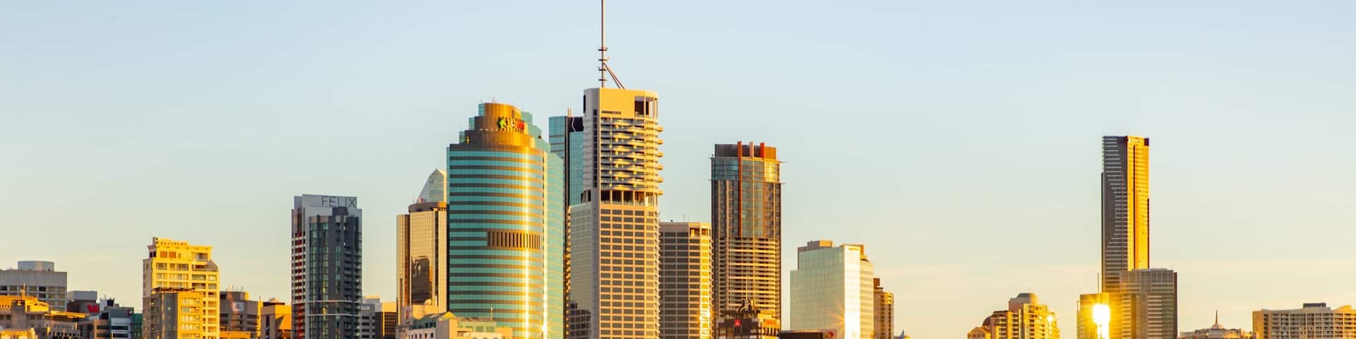 A city skyline with tall buildings and a marina filled with boats.