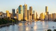 A city skyline with tall buildings and a marina filled with boats.