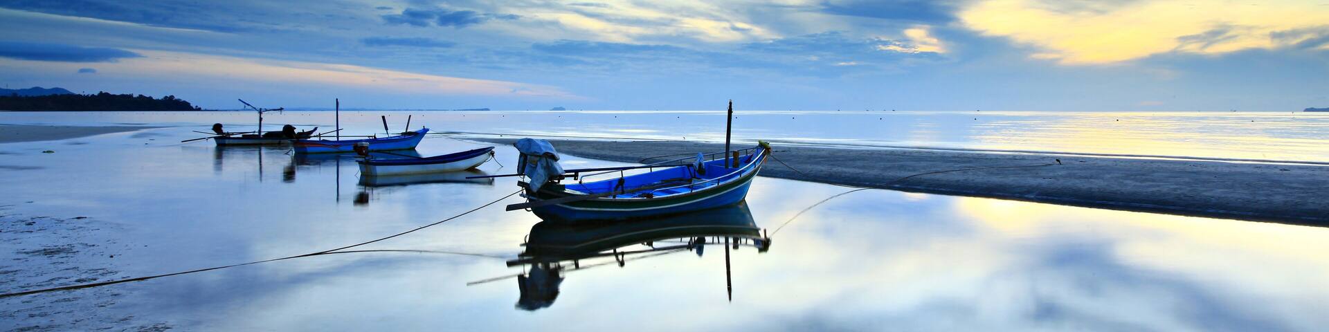 Fishing boats parked on the beach after the storm at thung wua laen beach, Saphli in Chumphon Province, Thailand