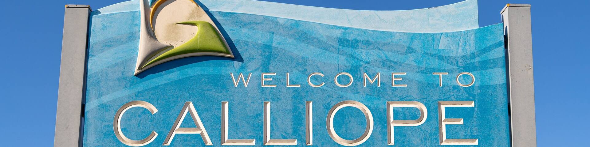 A blue welcome sign with the text "WELCOME TO CALLIOPE" and a stylized 'G' logo.