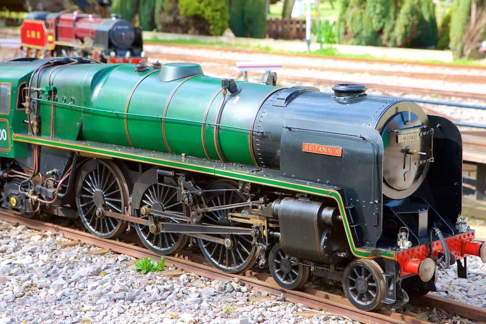 A green and black BRITANNIA steam locomotive on a railway track.