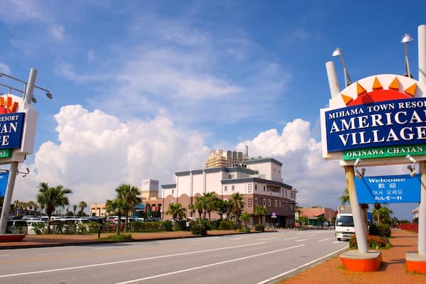A street with signs for Mihama Town Resort American Village and Okinawa Chatan.