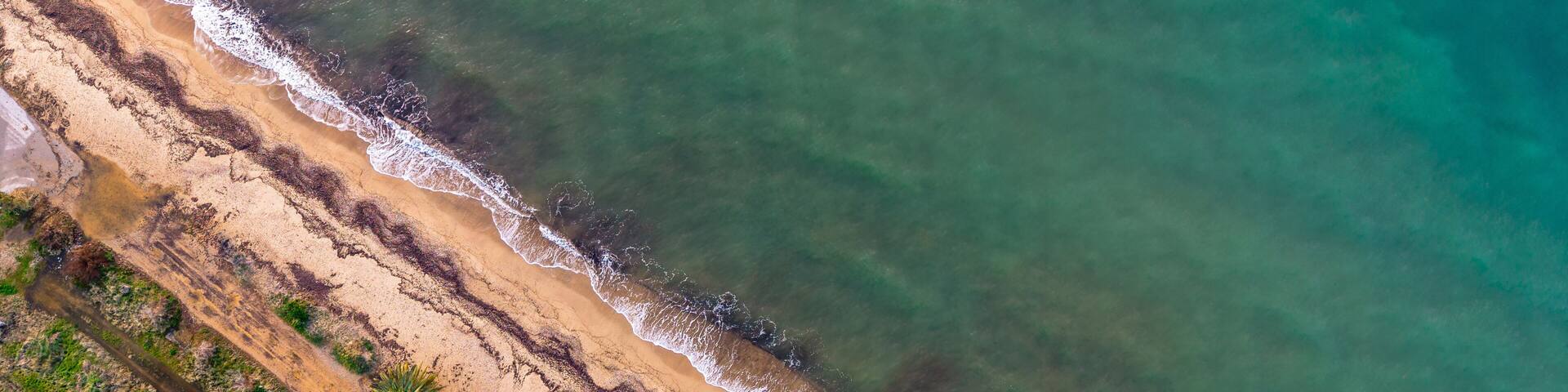 Aerial view of Paralia Portaria beach and Thermaic Gulf coastline, Central Macedonia, Greece