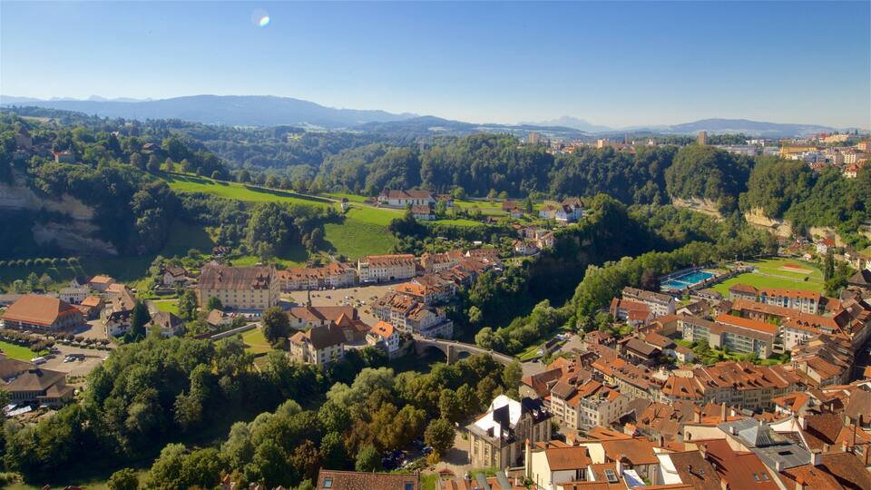 A town nestled in a valley with a river, surrounded by hills and mountains.