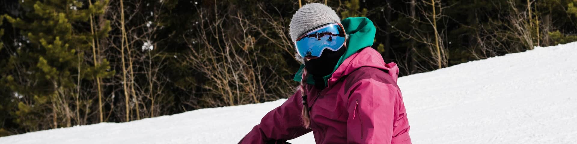 Woman Snowboarder Resting On The Snow