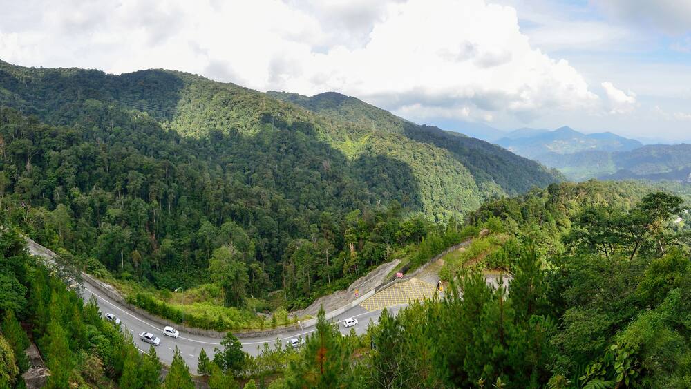 Curve road up to the Genting Highlands Malaysia with green tree and sky at Bentong Pahang.