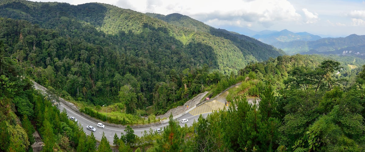 Curve road up to the Genting Highlands Malaysia with green tree and sky at Bentong Pahang.