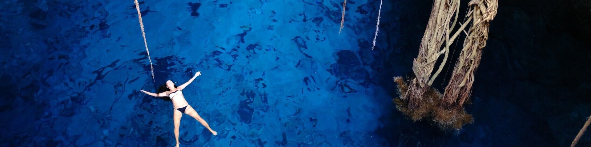 Cuama's Cenotes
Suppressing the similarities to the caving horror film ‘The Ascent’, this cenote is very special and very creepy. You will approach an incredible tree that may or may not come alive at night. There will be a steep ladder you will not want to climb down backwards. You will. Make your way through the stalactites and stalagmites to a body narrow body of water at the end of the stairs. You will not want to get into the black water but you will. It’s ‘fresh’ not cold, apparently. Also very deep, but do not think about that as flashbacks from The Ascent will absolutely kick in. You will swim for about 10 meters and climb back out of the blackness, unscathed. Make your way back to your belongings and smile as the next cenotes are much less creepy!