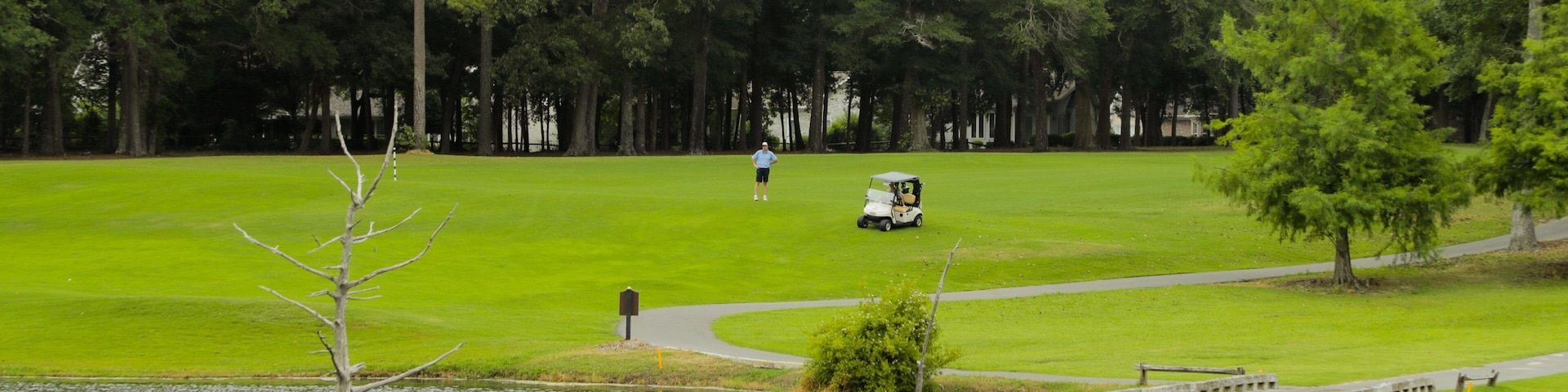 Arcadian Shores Golf Club which includes golf, a bridge and a pond