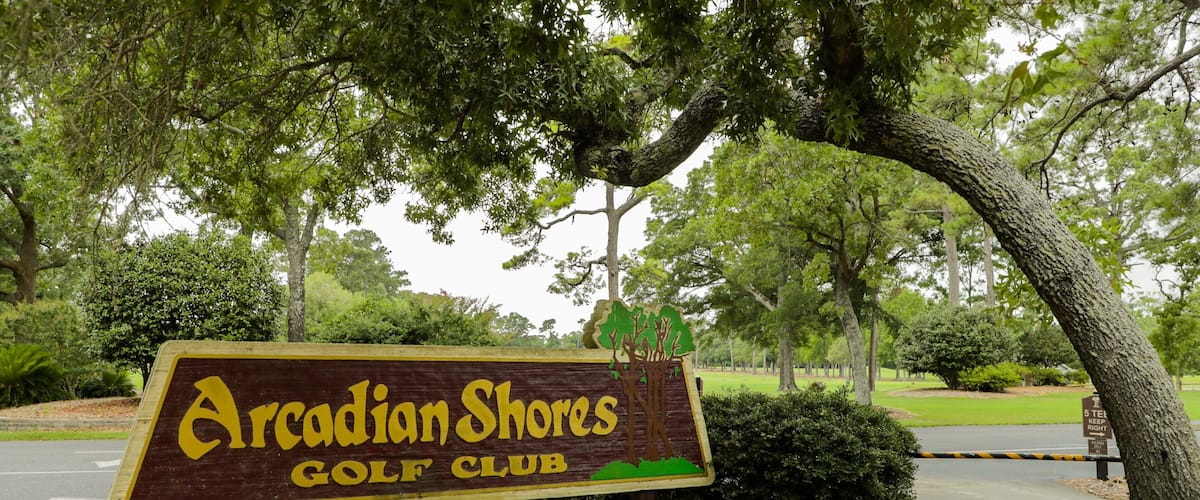 Arcadian Shores Golf Club featuring signage and golf