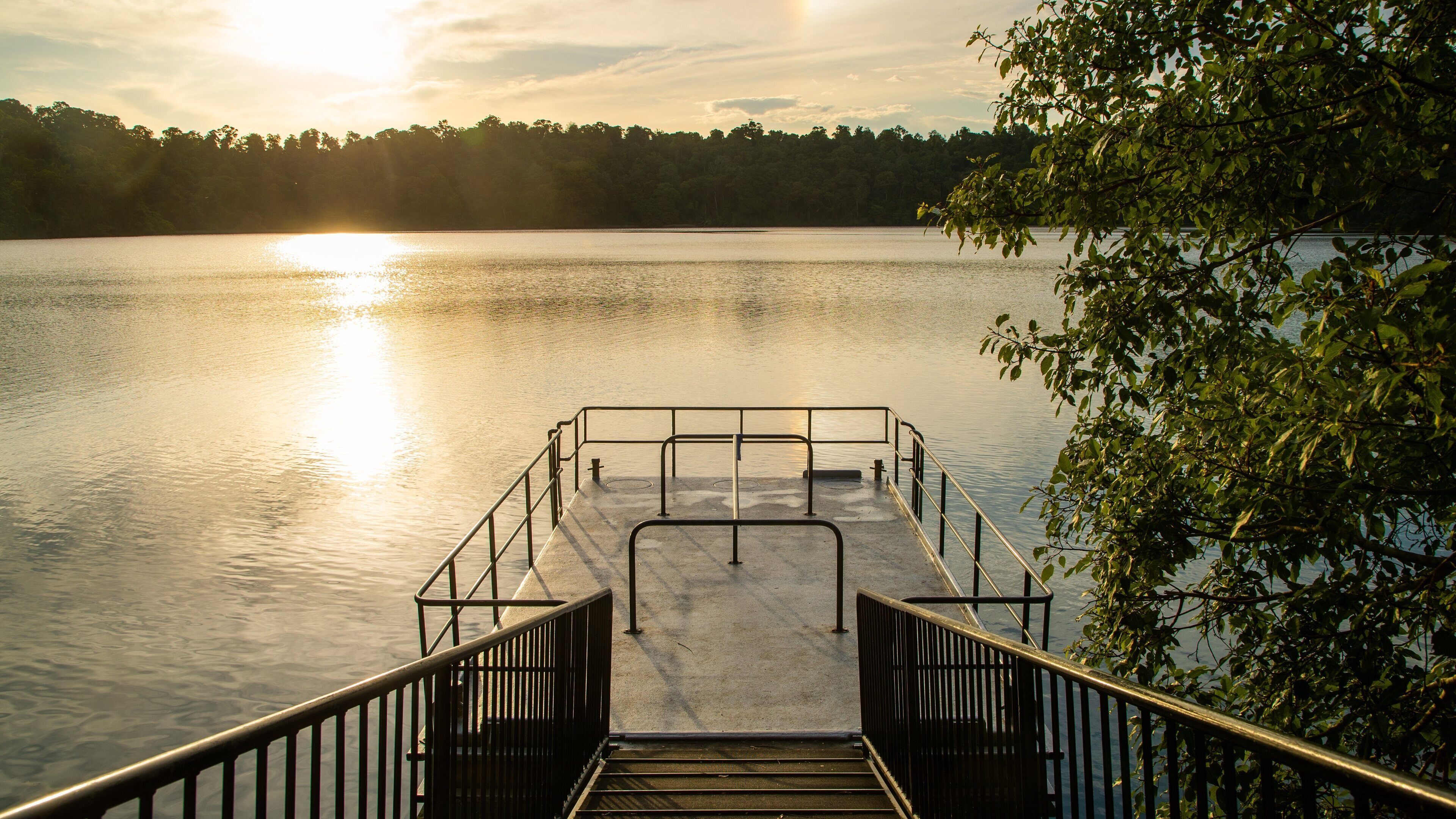 Lake Eacham featuring a lake or waterhole and a sunset