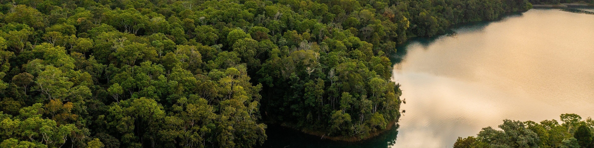 Lake Eacham featuring tranquil scenes, landscape views and a sunset