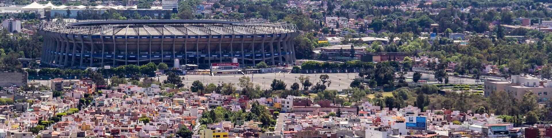 aerial view of azteca stadium and iconic snowed volcanoes in the back