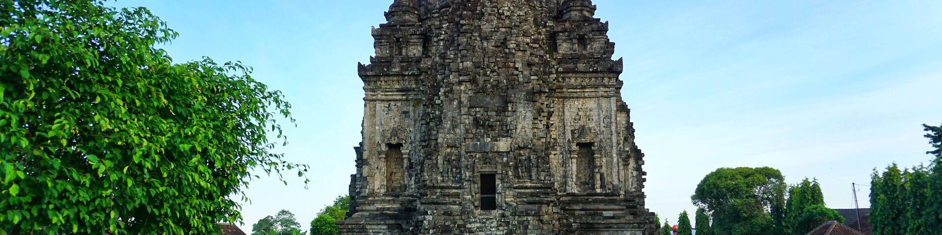 An ancient temple with a steep, tiered roof and intricate stone carvings.