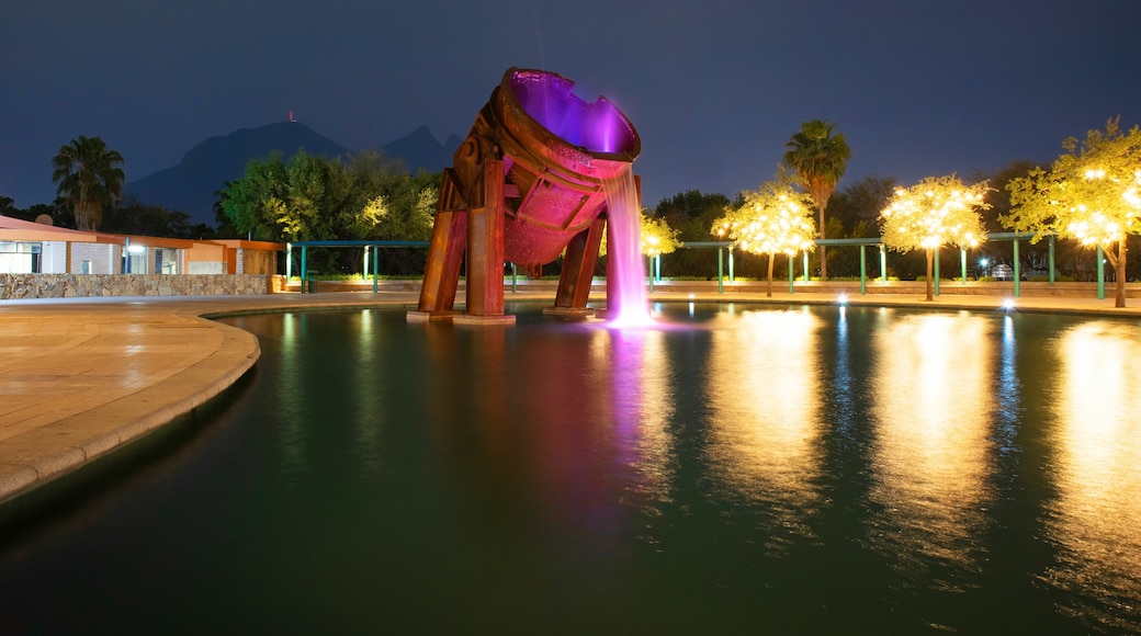 Paseo de Santa Lucia riverwalk Fuente del Crisol at Parque Fundidora Park at Night with Cerro de la Silla at the background, Monterrey, Nuevo Leon, Mexico