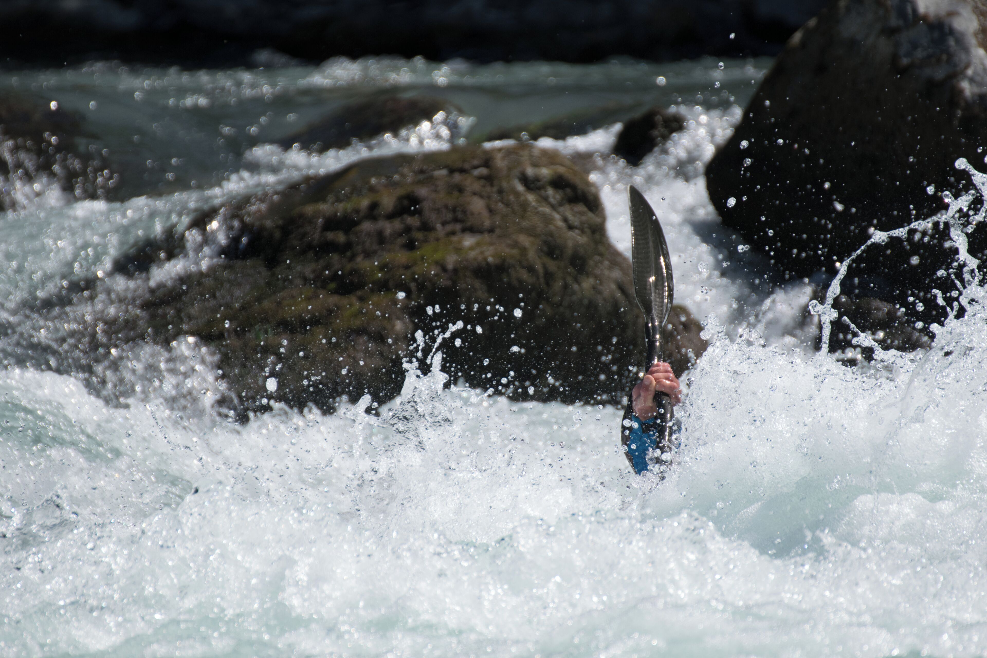 Kayaker playboating at the Rabioux, on the Durance river (France).