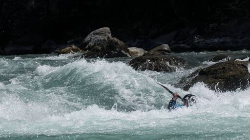 Kayaker playboating at the Rabioux, on the Durance river (France).