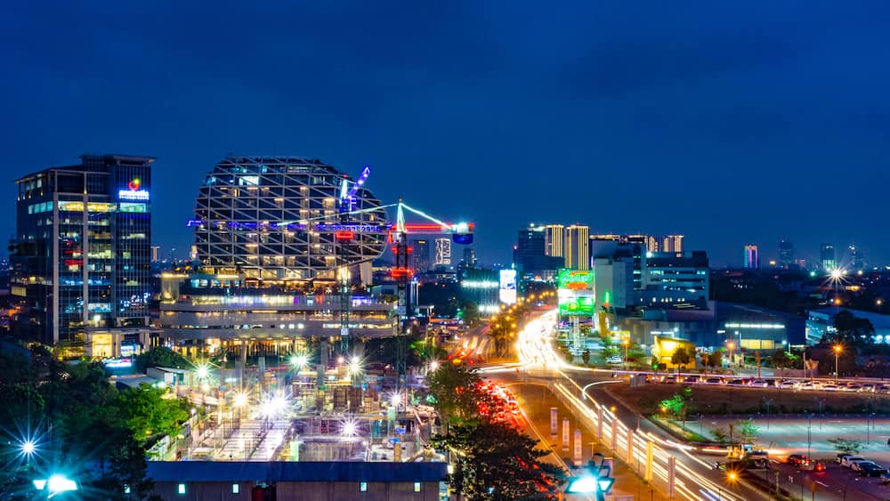 Tangerang, Indonesia - 26th Sept 2019: The scenery at Gading Serpong Boulevard at night. Long exposure photo with light trails. Gading Serpong is a luxury real estate with high property investment.