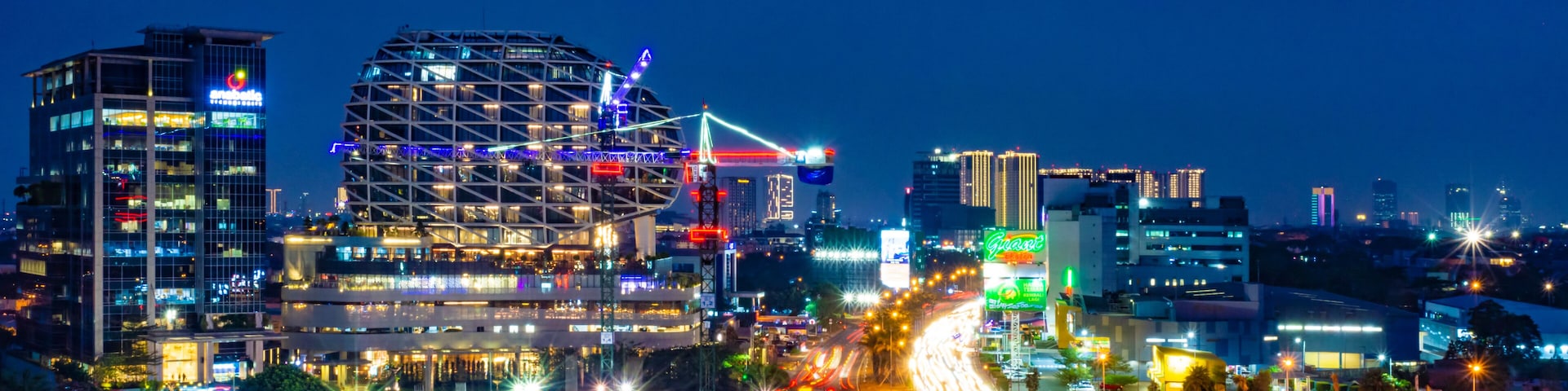Tangerang, Indonesia - 26th Sept 2019: The scenery at Gading Serpong Boulevard at night. Long exposure photo with light trails. Gading Serpong is a luxury real estate with high property investment.