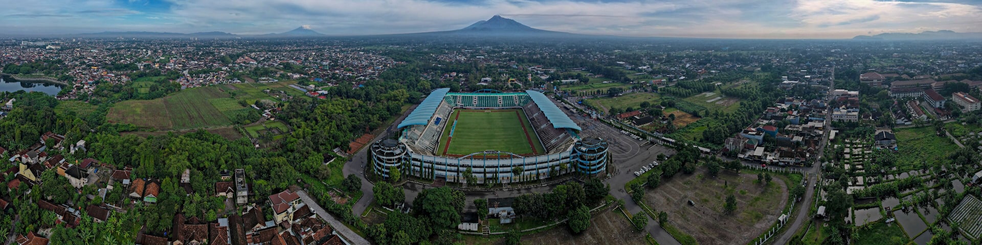 Sleman Yogyakarta, April 6, 2022 : View of Maguwoharjo Stadium from the air on a sunny morning. view of the stadium against the backdrop of the majestic Mount Merapi.