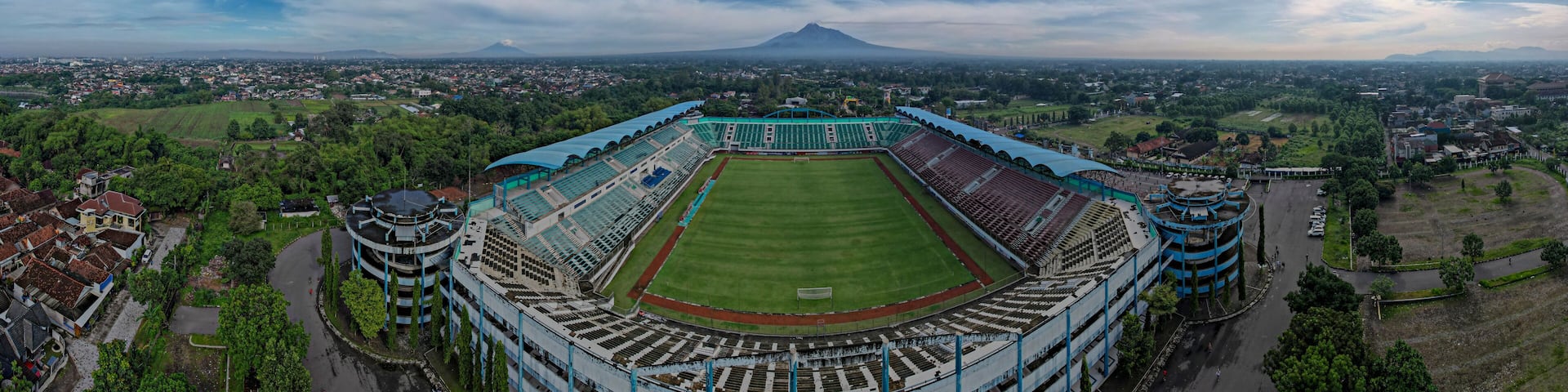 Sleman Yogyakarta, April 6, 2022 : View of Maguwoharjo Stadium from the air on a sunny morning. view of the stadium against the backdrop of the majestic Mount Merapi.