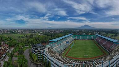Sleman Yogyakarta, April 6, 2022 : View of Maguwoharjo Stadium from the air on a sunny morning. view of the stadium against the backdrop of the majestic Mount Merapi.