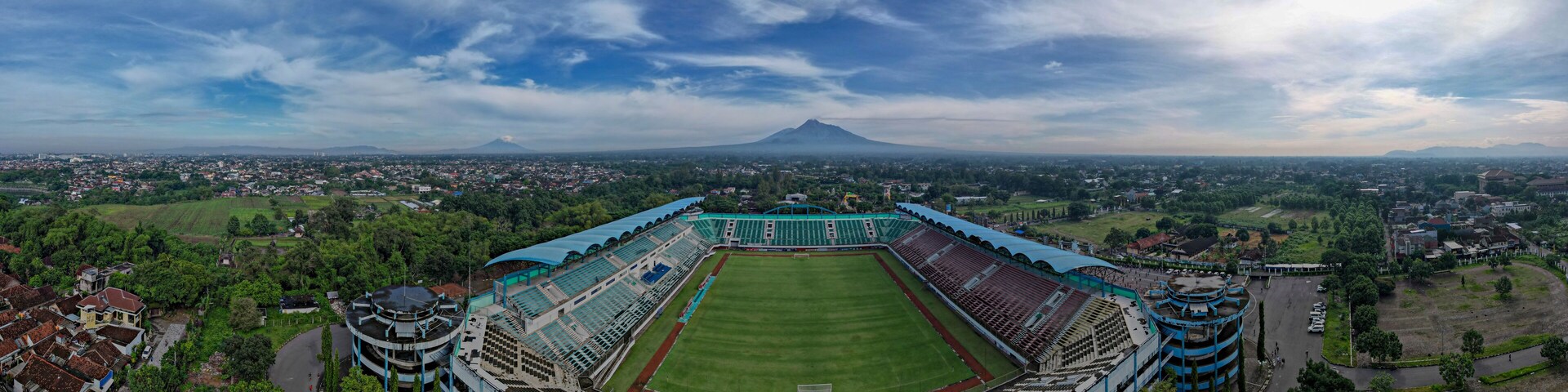 Sleman Yogyakarta, April 6, 2022 : View of Maguwoharjo Stadium from the air on a sunny morning. view of the stadium against the backdrop of the majestic Mount Merapi.