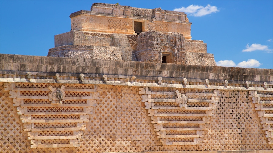 A stone structure with intricate carvings and a clear blue sky.