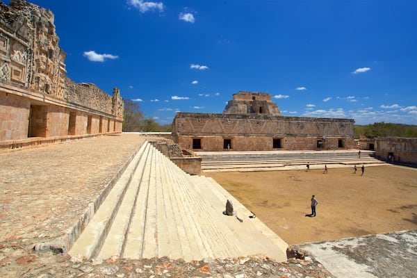 An ancient stone structure with stepped platforms and a large open courtyard.