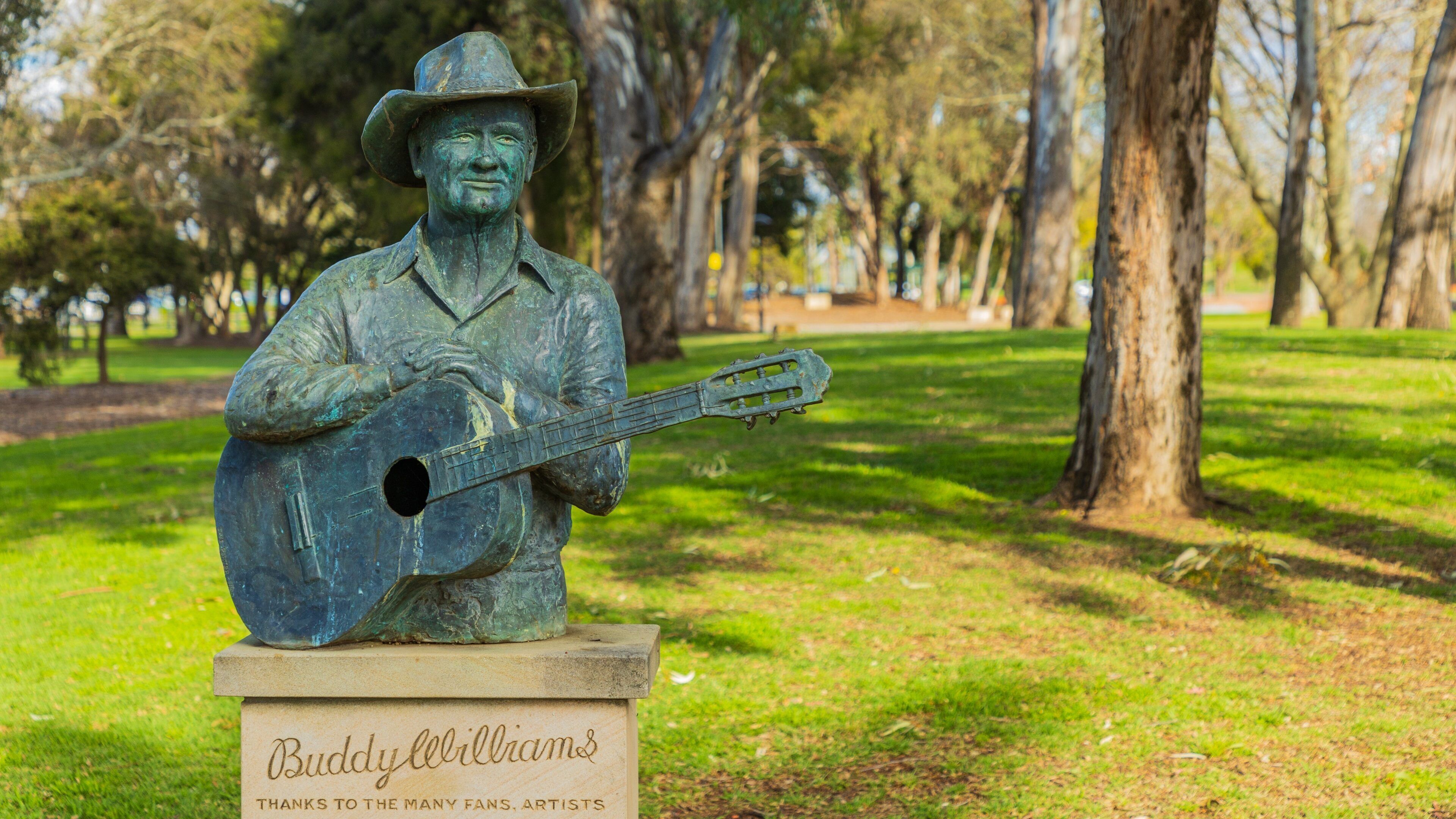 Bicentennial Park featuring a statue or sculpture and a garden