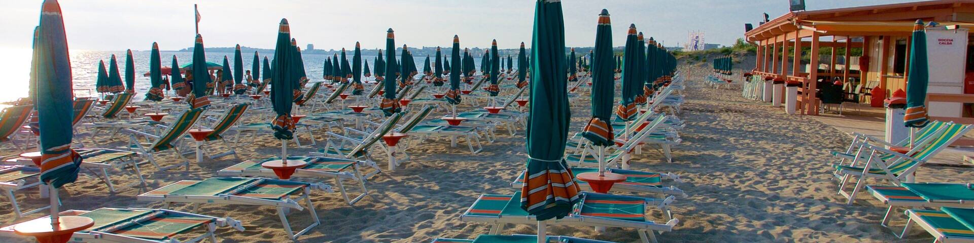 Baia Verde Beach featuring a sunset and a sandy beach