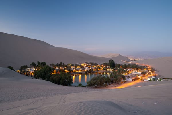 This image shows the oasis town of Huacachina, Peru at night