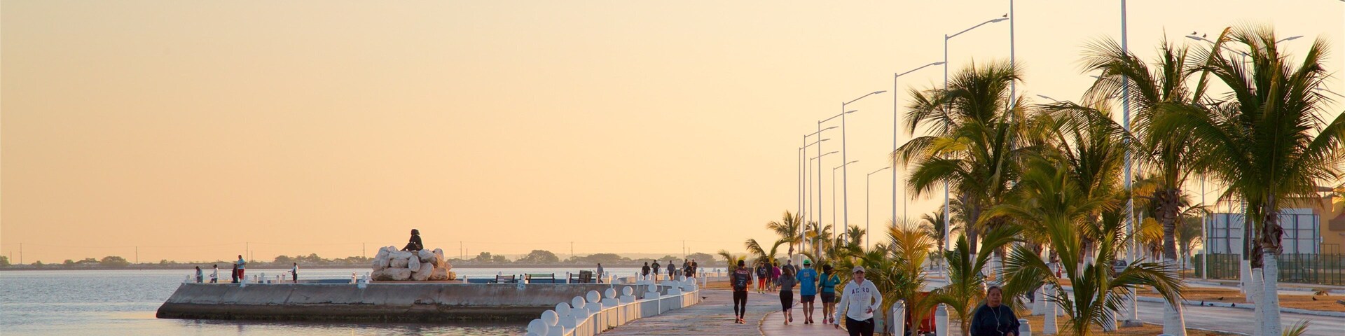 Campeche Waterfront Promenade which includes a sunset, hiking or walking and a bay or harbor