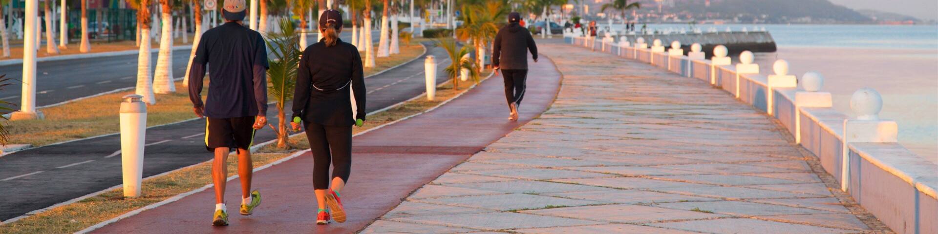 Campeche Waterfront Promenade showing hiking or walking and a sunset as well as a couple