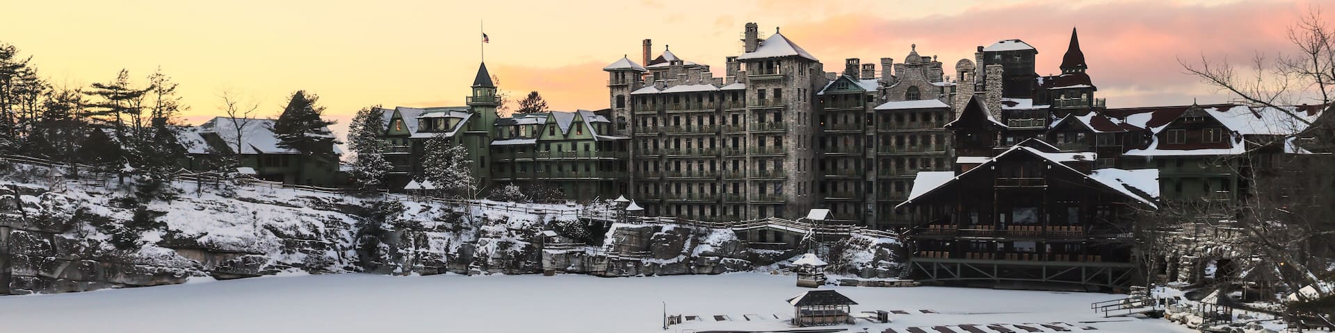 sunset view of famous hotel and wooden gazebo along hiking trail in upstate new york near new paltz (shawangunk mountain) winter snow house mohonk preserve frozen lake hike blizzard