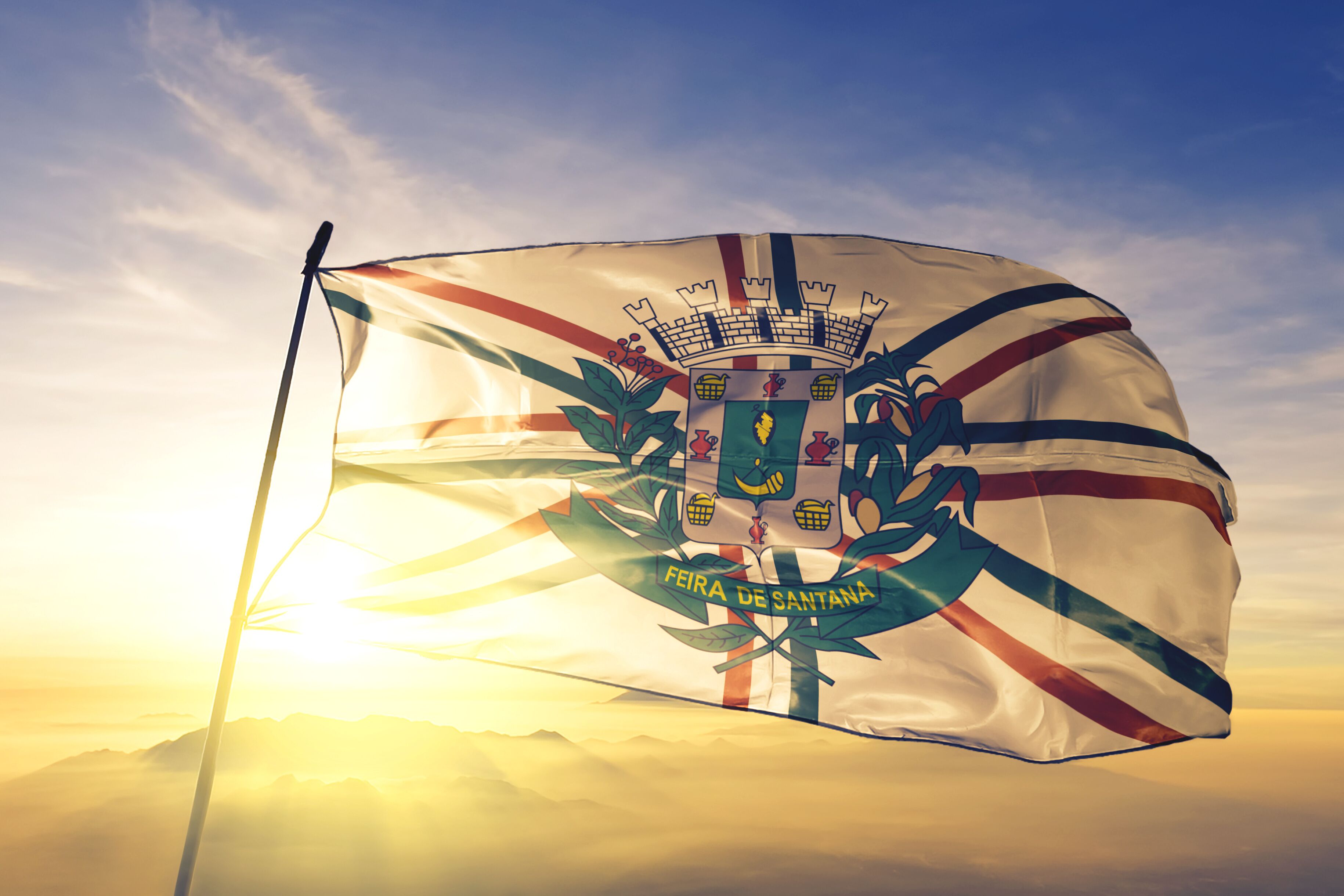 Feira de Santana of Brazil flag waving on the top sunrise mist fog