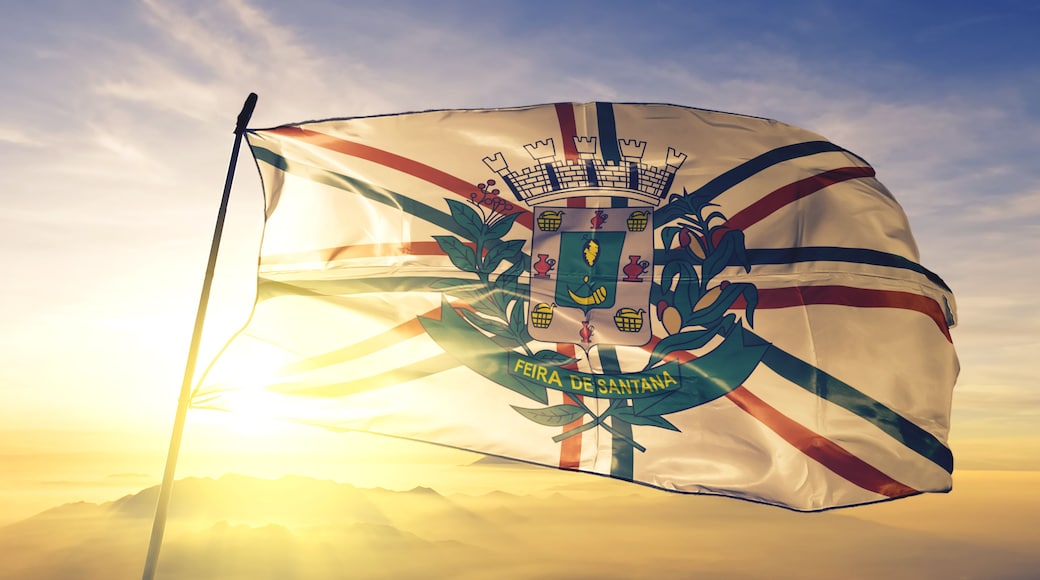 Feira de Santana of Brazil flag waving on the top sunrise mist fog