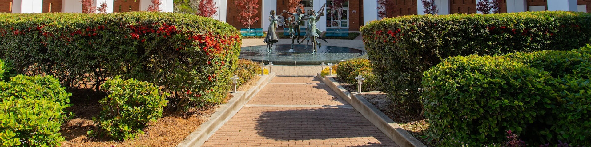 Northwest Florida State College showing a fountain, a statue or sculpture and a garden