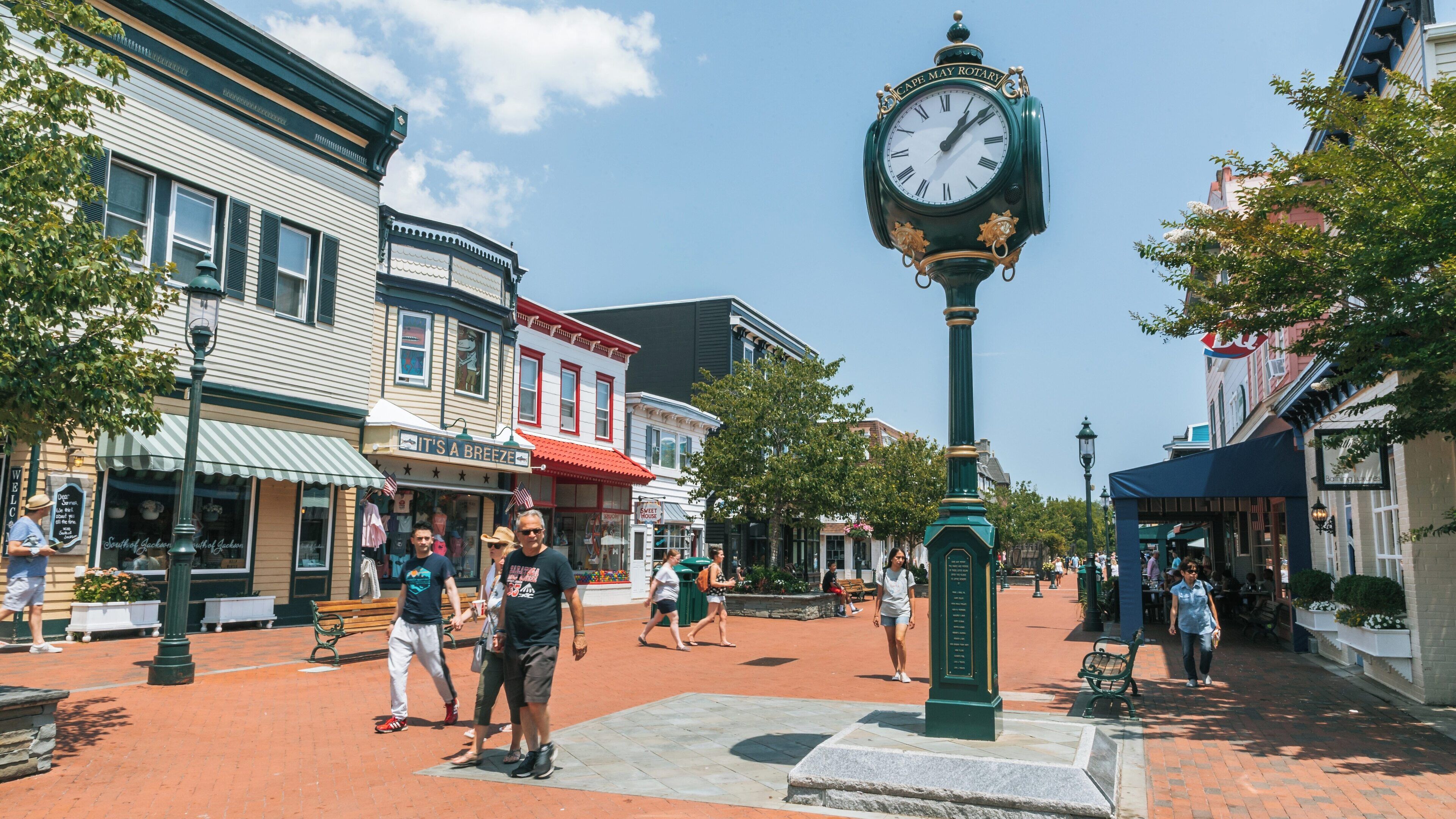 Visitors enjoy a sunny day at Washington Street Mall in Cape May Historic District with charming shops and a prominent clock