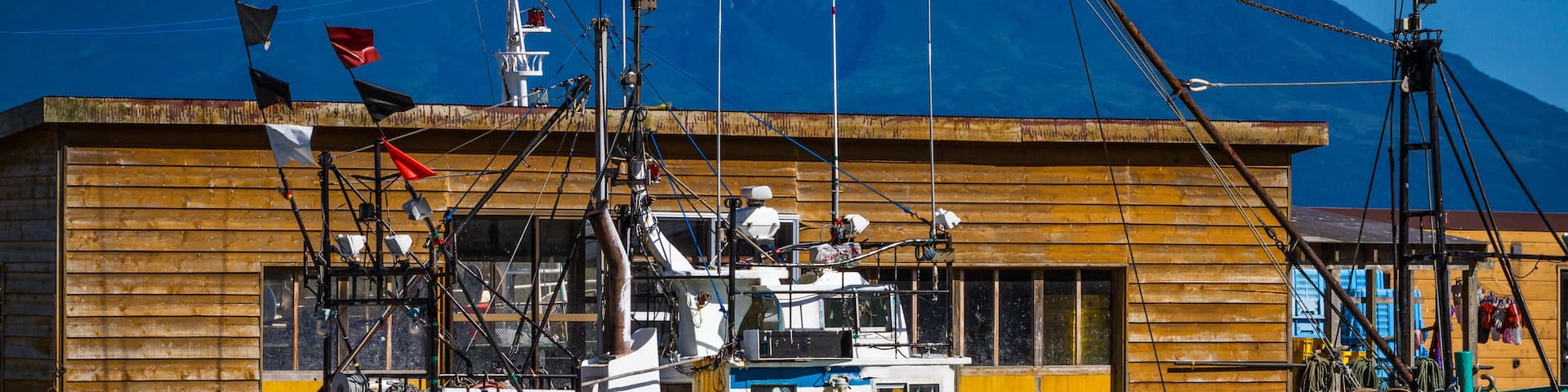 Typical fishing boat on Rebun Island, Japan, in the island's main harbor in the Tonnai section of Kafuka Village, Mt. Rishiri in the distance, Shutterstock ID 784093528, Purchase Order: -