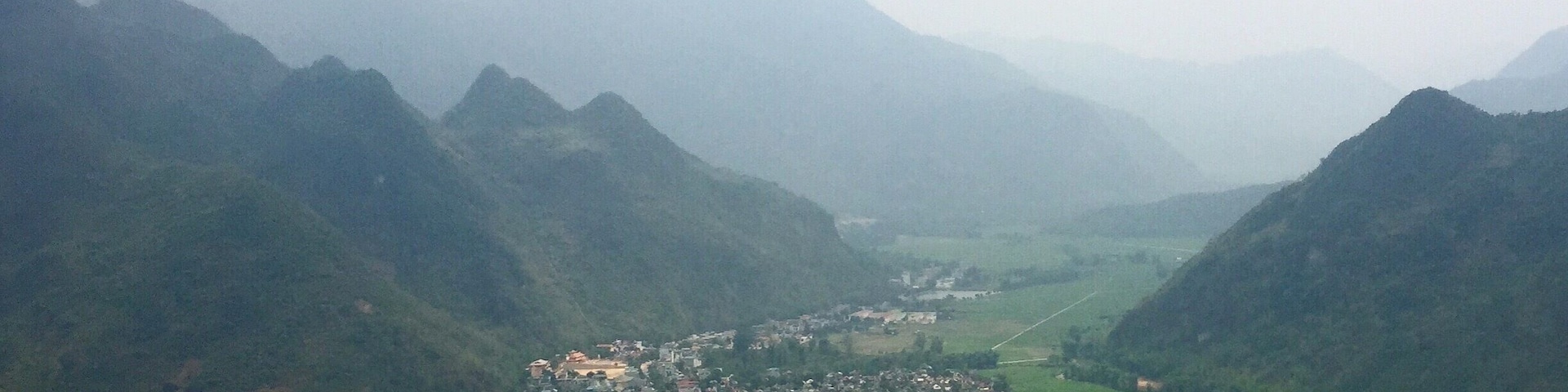 A valley with a town nestled between mountains.