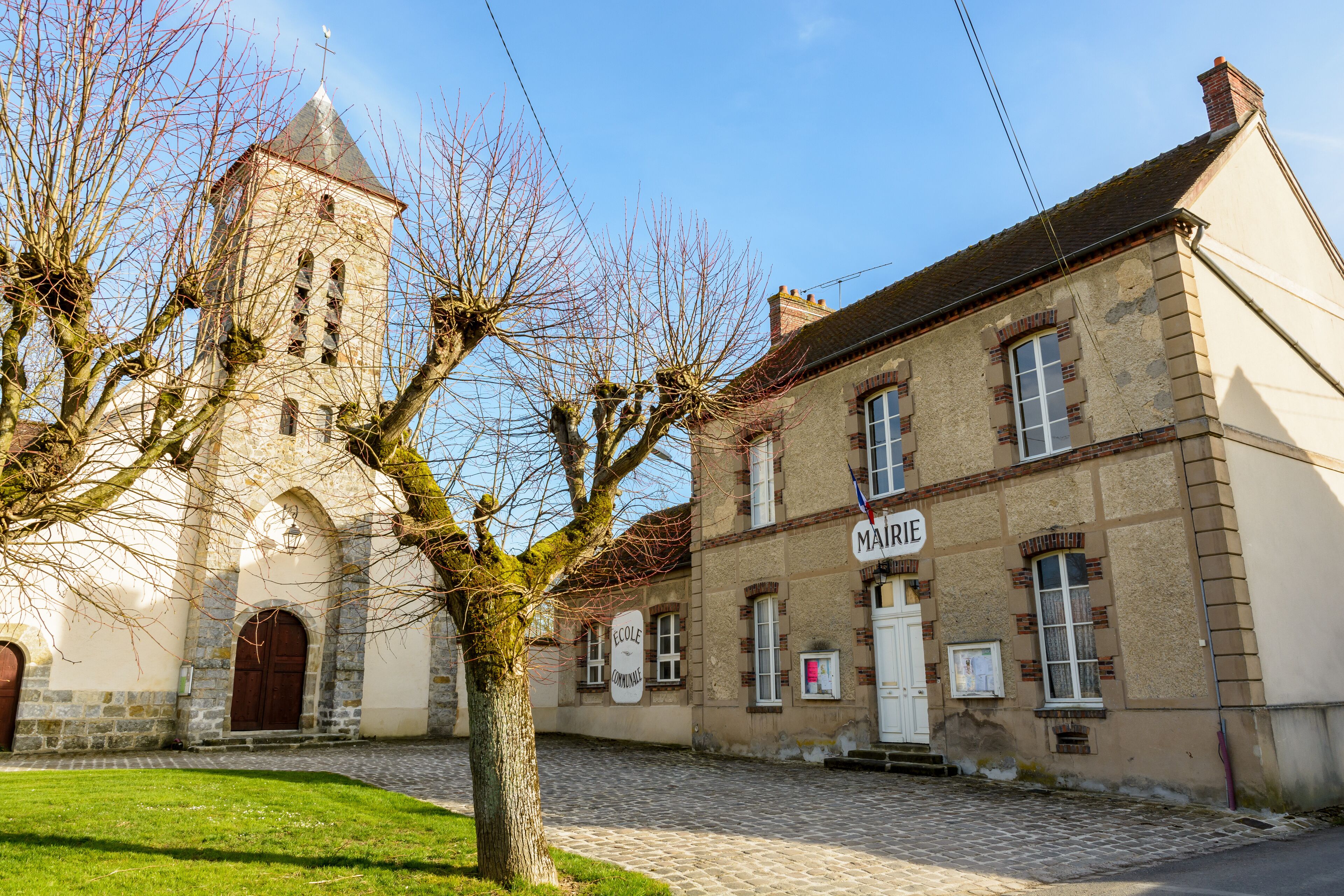 A historic building with a tower and a sign that reads "MAIRIE".