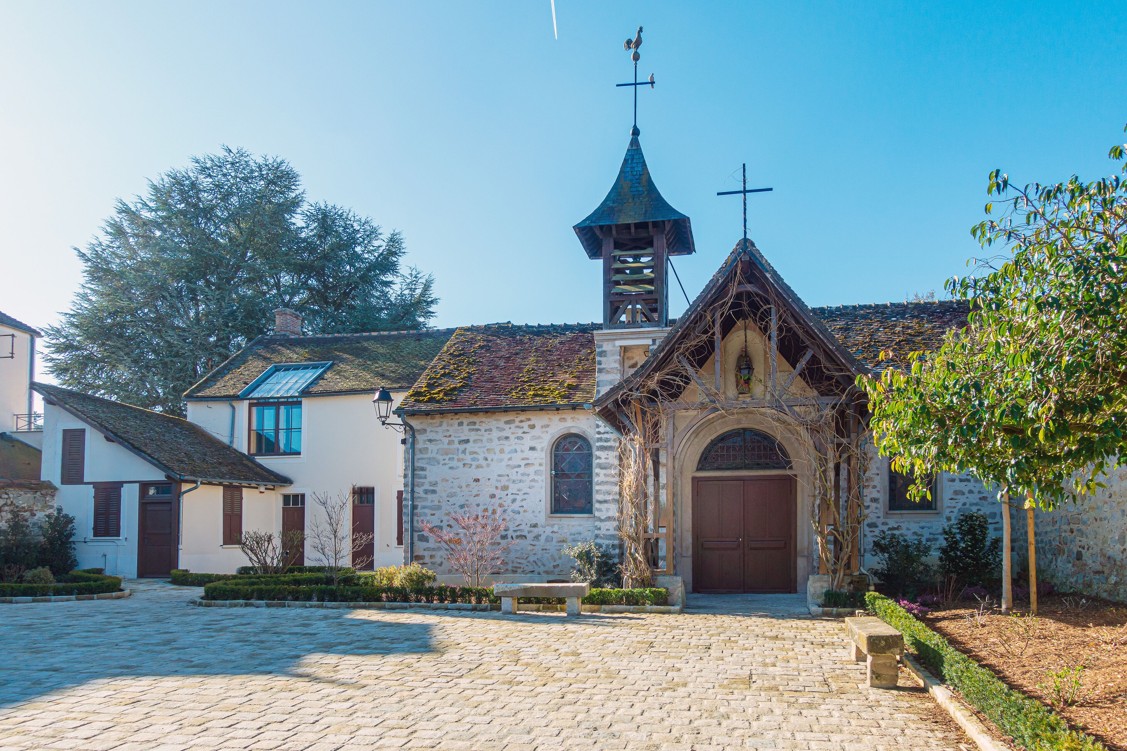 A stone church with a bell tower and arched entrance.