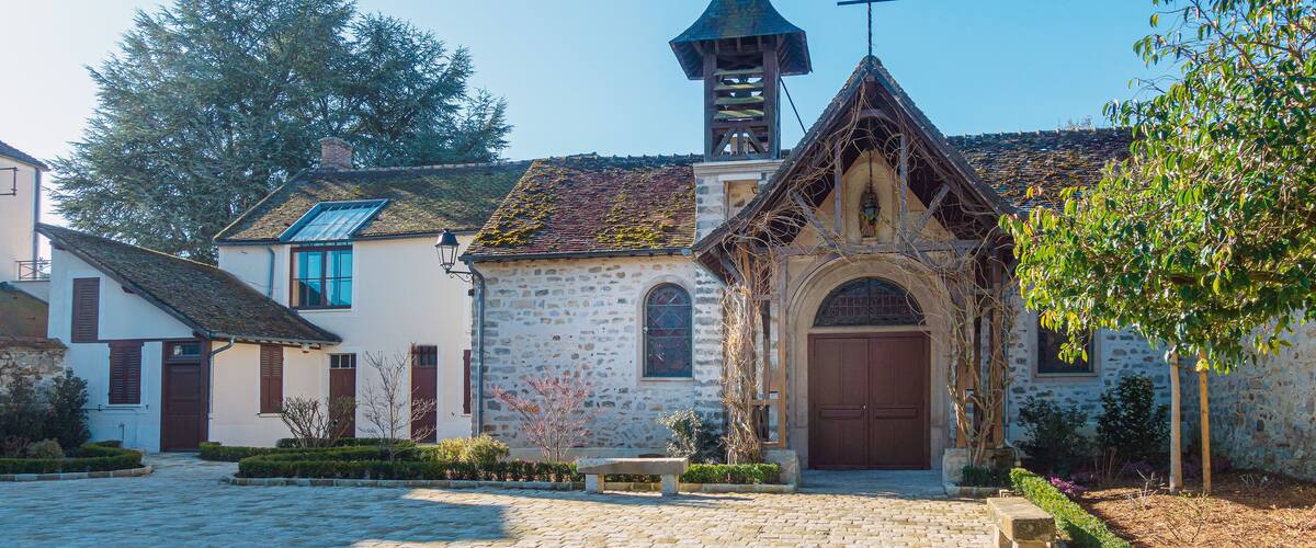 A stone church with a bell tower and arched entrance.