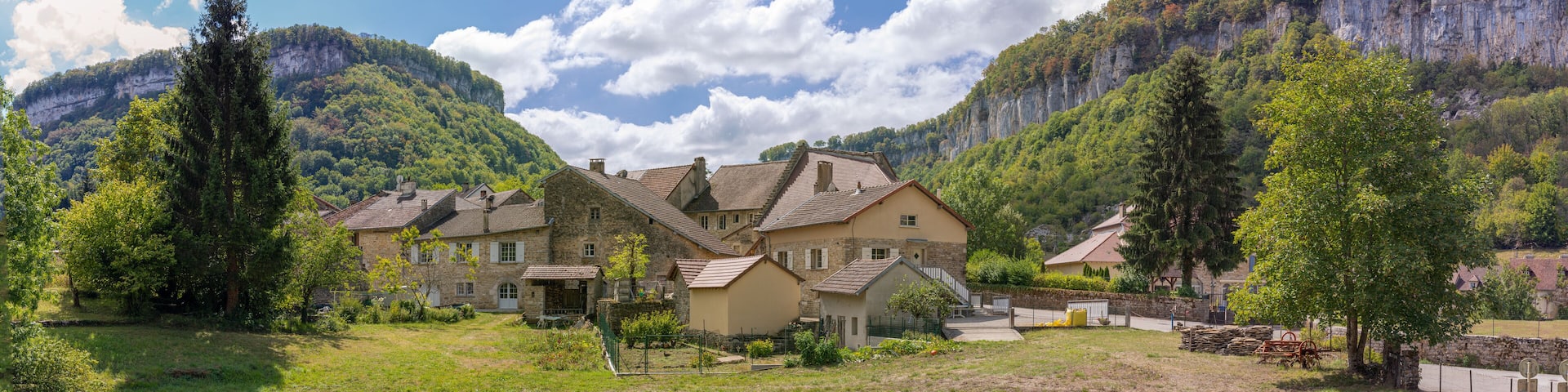 Baume-Les-Messieurs, France - 09 01 2020: View of the village of Baume-les-Messieurs and cliffs behind