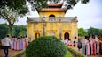 Hanoi Citadel featuring a temple or place of worship as well as a small group of people