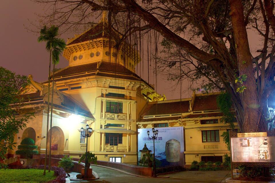 A historic building with traditional architecture, illuminated by artificial lighting at night.