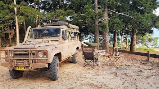 A simple setup at Platypus on the shores of Lake Tinaroo near Tolga on Queensland's Atherton Tablelands. A chair and two camp tables as combination camp kitchen and office, then a hammock tied between the Landy's roll bar and a big old beautiful kauri pine tree - a work of art with the backdrop of Lake Tinaroo as the canvas.